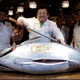 Kiyoshi Kimura, president of sushi restaurant chain store operator Kiyomura Co., poses with his tuna. (EPA/Kiyoshi Ota)